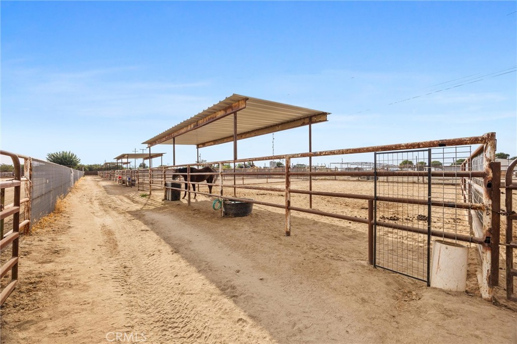 30751 Sharp Shafter, CA 93263 - Photo 55 of 73 a view of a terrace with a table and chairs under an umbrella