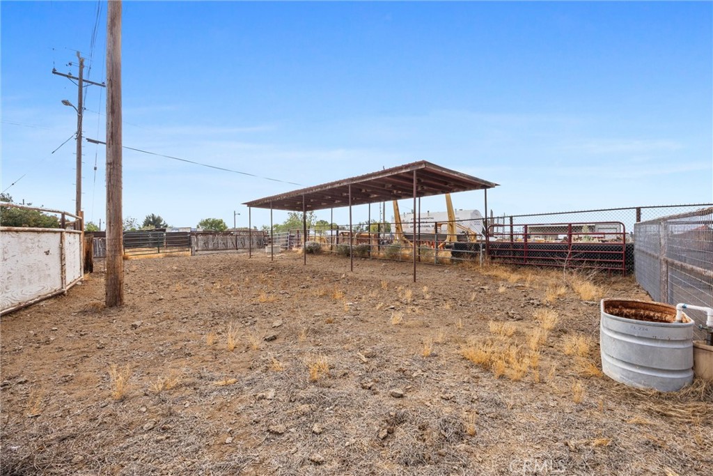 30751 Sharp Shafter, CA 93263 - Photo 58 of 73 a backyard of a house with table and chairs under an umbrella