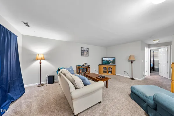 a living room with furniture and a lamp