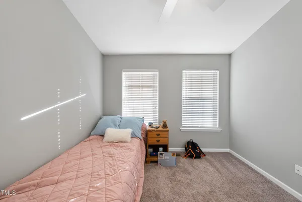 a bedroom with a bed a couch and a window