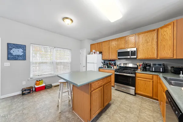 a kitchen with stainless steel appliances a stove sink microwave and refrigerator
