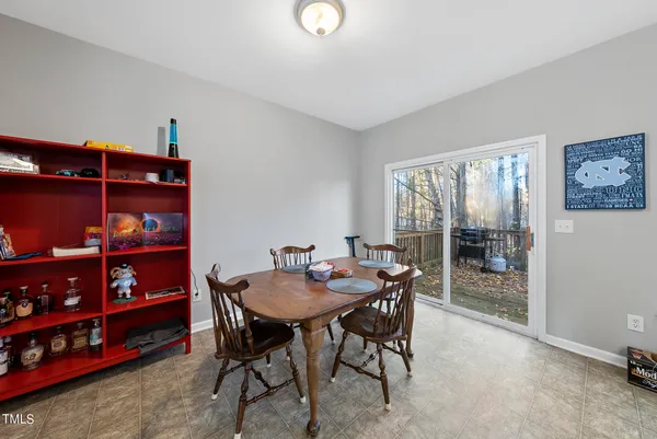 a dining room with furniture and a window