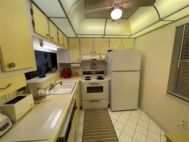 a kitchen with a sink appliances and cabinets