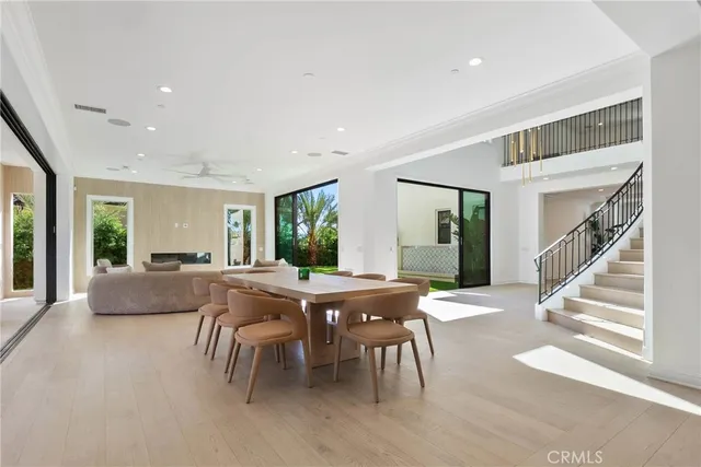 a large white kitchen with sink stove and cabinets