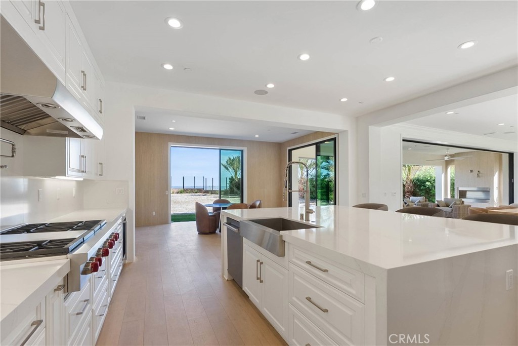20448 Liverpool Way Porter Ranch, CA 91326 - Photo 18 of 60 a large white kitchen with sink stove and cabinets