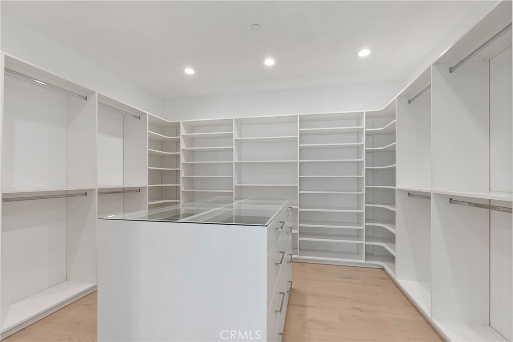 20448 Liverpool Way Porter Ranch, CA 91326 - Photo 36 of 60 a view of walk in closet with empty racks