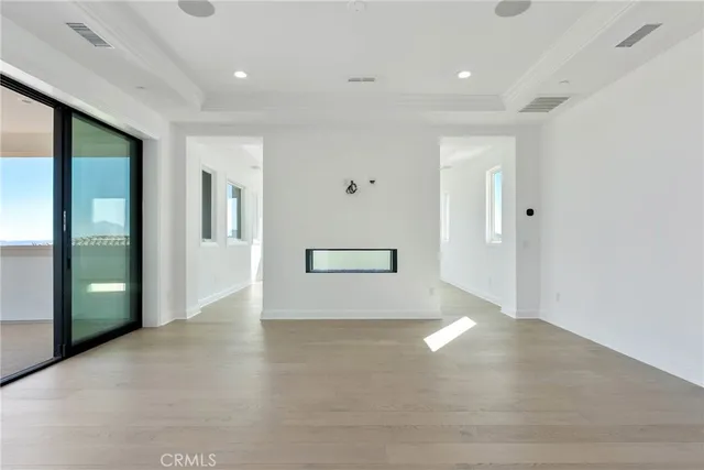 a view of a white house with a big yard and large trees