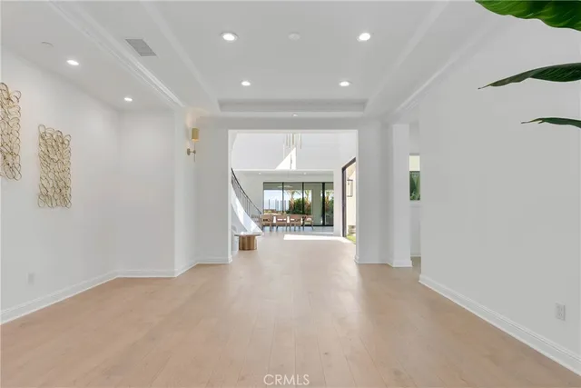 a dining room with furniture and a floor to ceiling window
