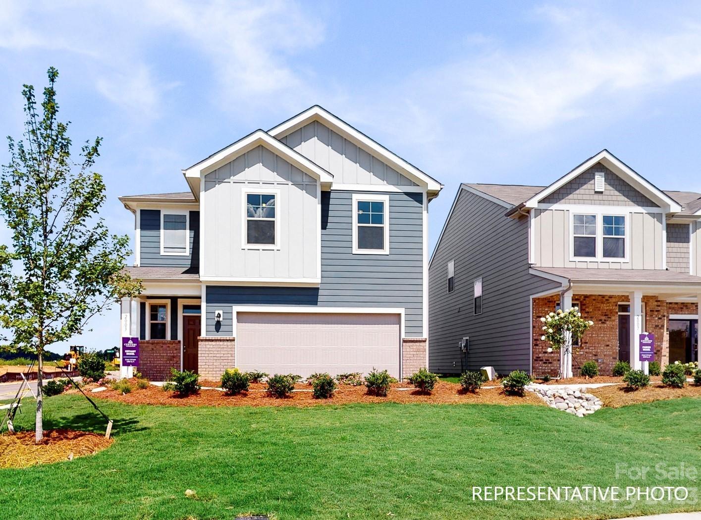 4911 Raspberry Knoll Drive, Unit 41 Charlotte, NC 28208 - Photo 1 of 29 a front view of a house with a yard and garage