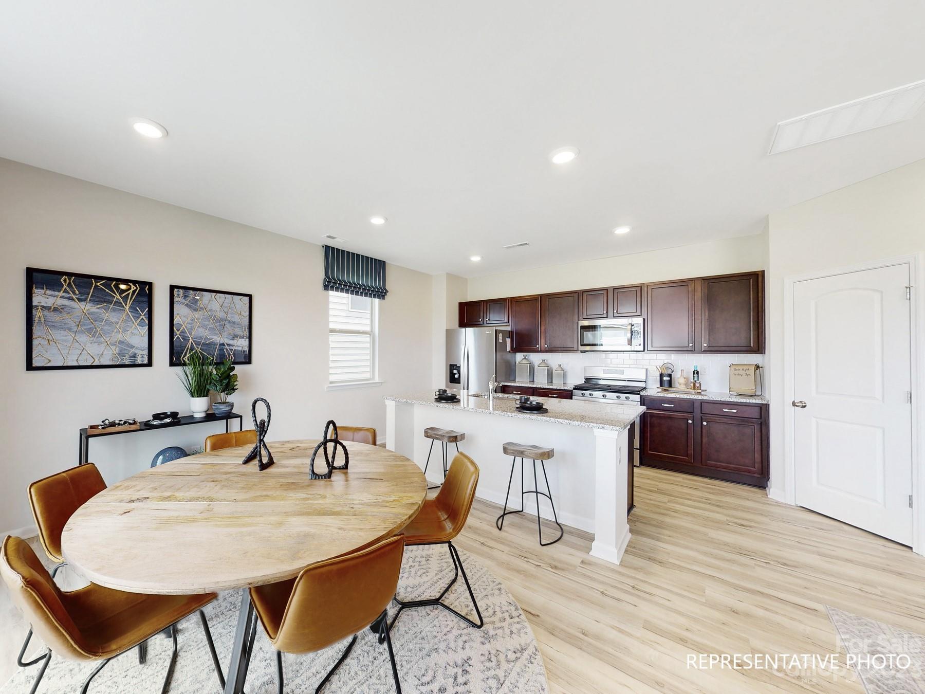 4911 Raspberry Knoll Drive, Unit 41 Charlotte, NC 28208 - Photo 13 of 29 a large kitchen with a table and chairs in it