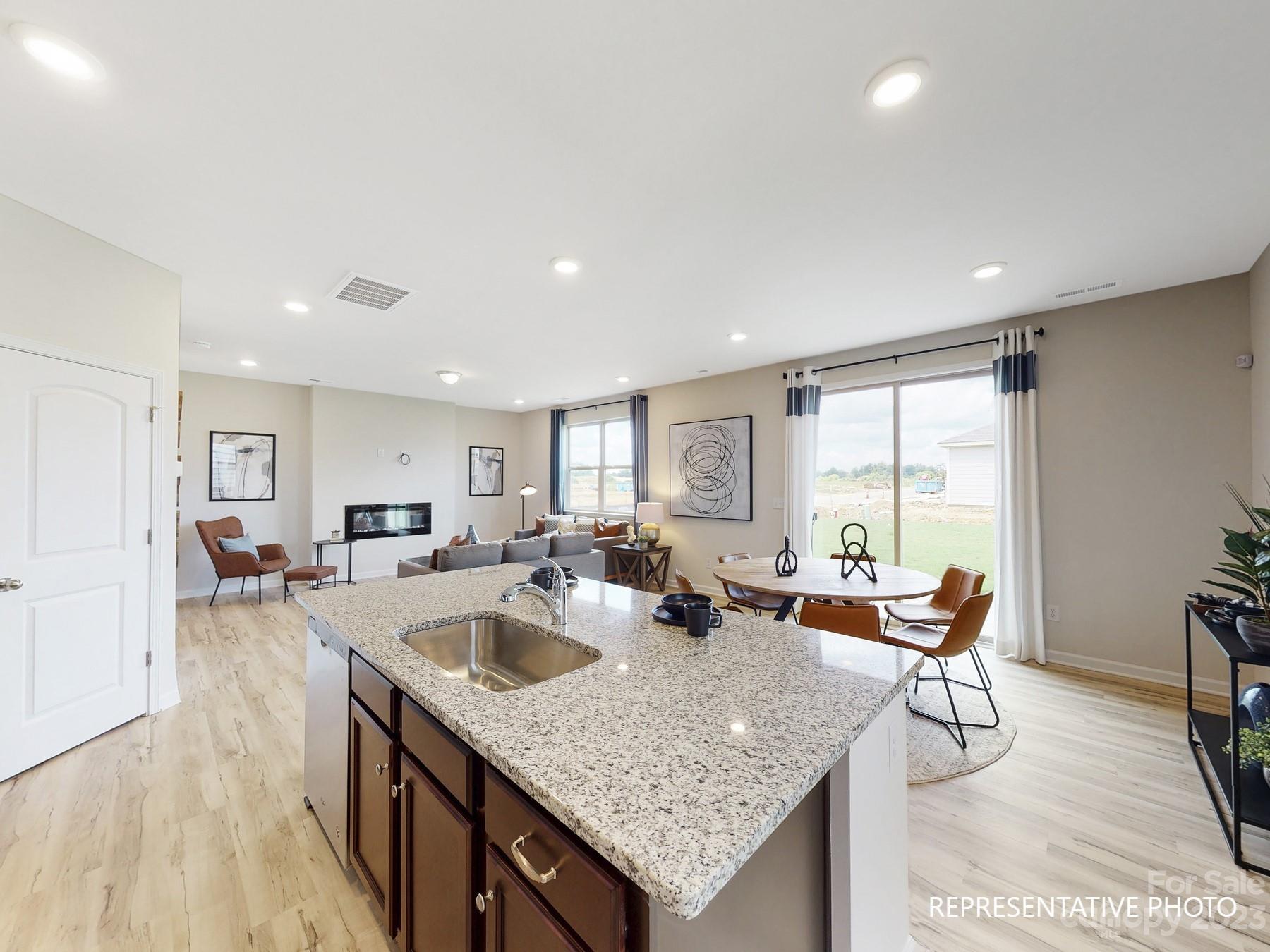 4911 Raspberry Knoll Drive, Unit 41 Charlotte, NC 28208 - Photo 14 of 29 a view of a dining room with furniture and wooden floor