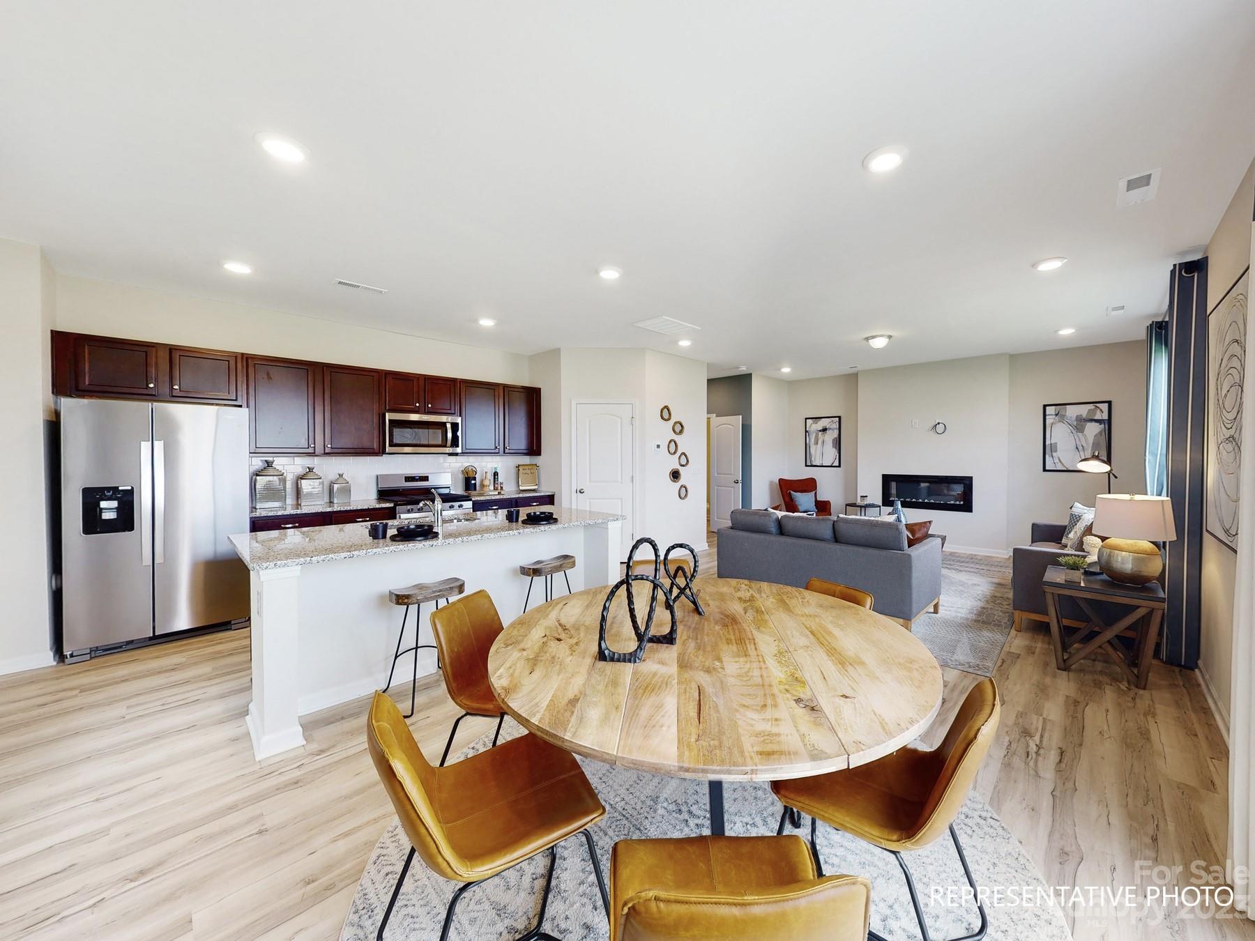 4911 Raspberry Knoll Drive, Unit 41 Charlotte, NC 28208 - Photo 15 of 29 a view of a dining room with furniture and wooden floor