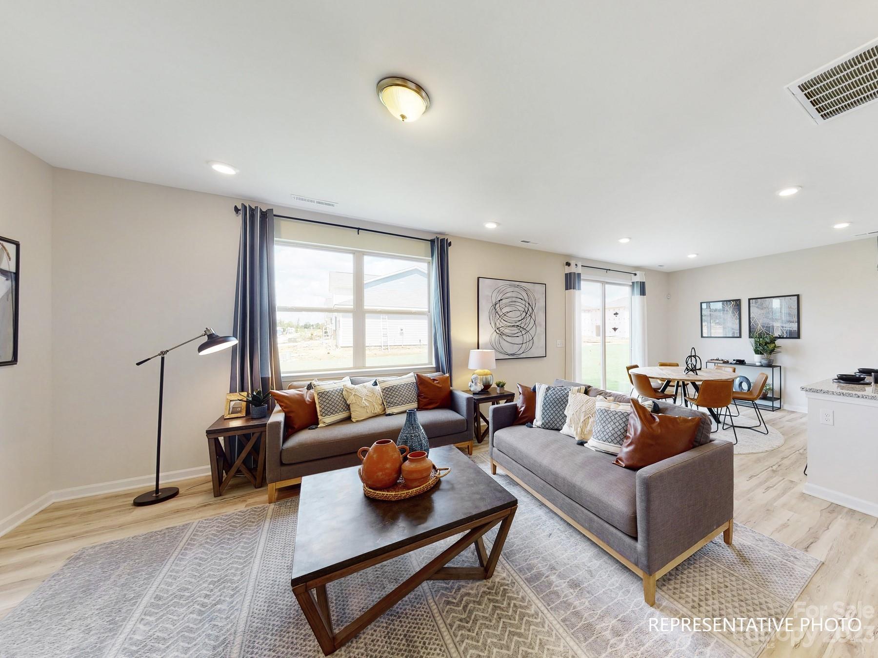 4911 Raspberry Knoll Drive, Unit 41 Charlotte, NC 28208 - Photo 19 of 29 a living room with furniture rug and window