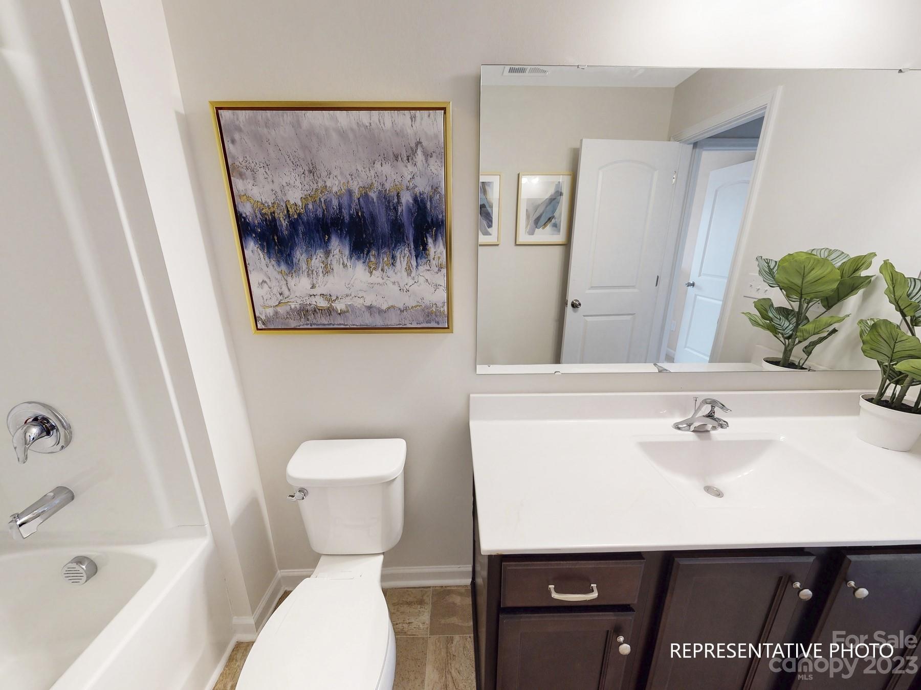 4911 Raspberry Knoll Drive, Unit 41 Charlotte, NC 28208 - Photo 2 of 29 a bathroom with a sink a toilet and shower