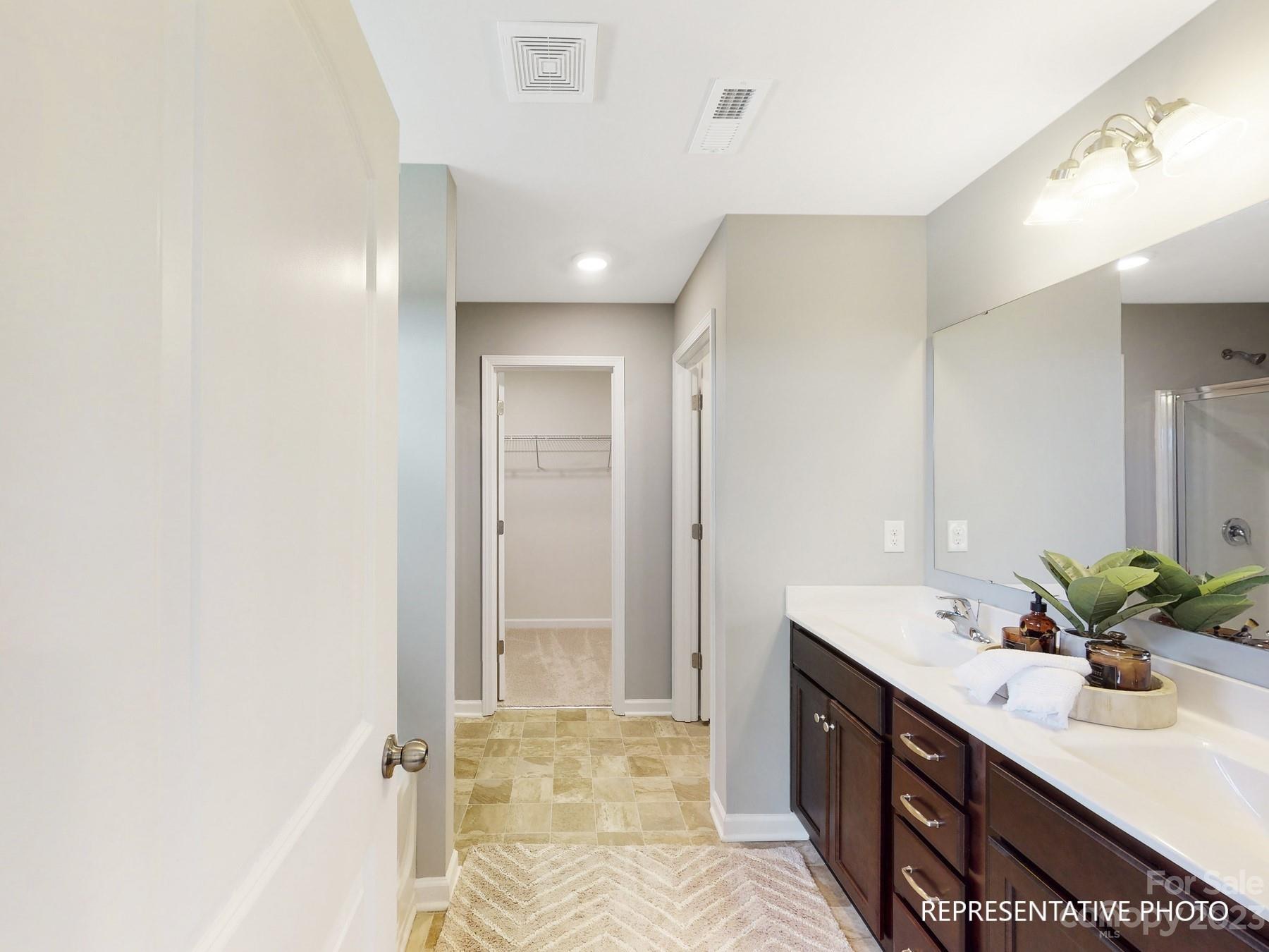 4911 Raspberry Knoll Drive, Unit 41 Charlotte, NC 28208 - Photo 23 of 29 a bathroom with a double vanity sink and mirror