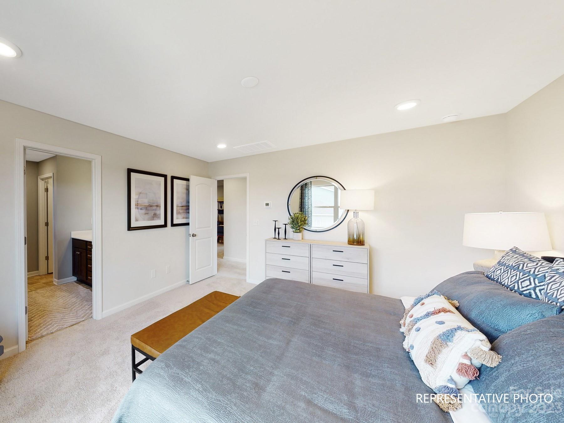 4911 Raspberry Knoll Drive, Unit 41 Charlotte, NC 28208 - Photo 24 of 29 a bed room with a bed and a mirror