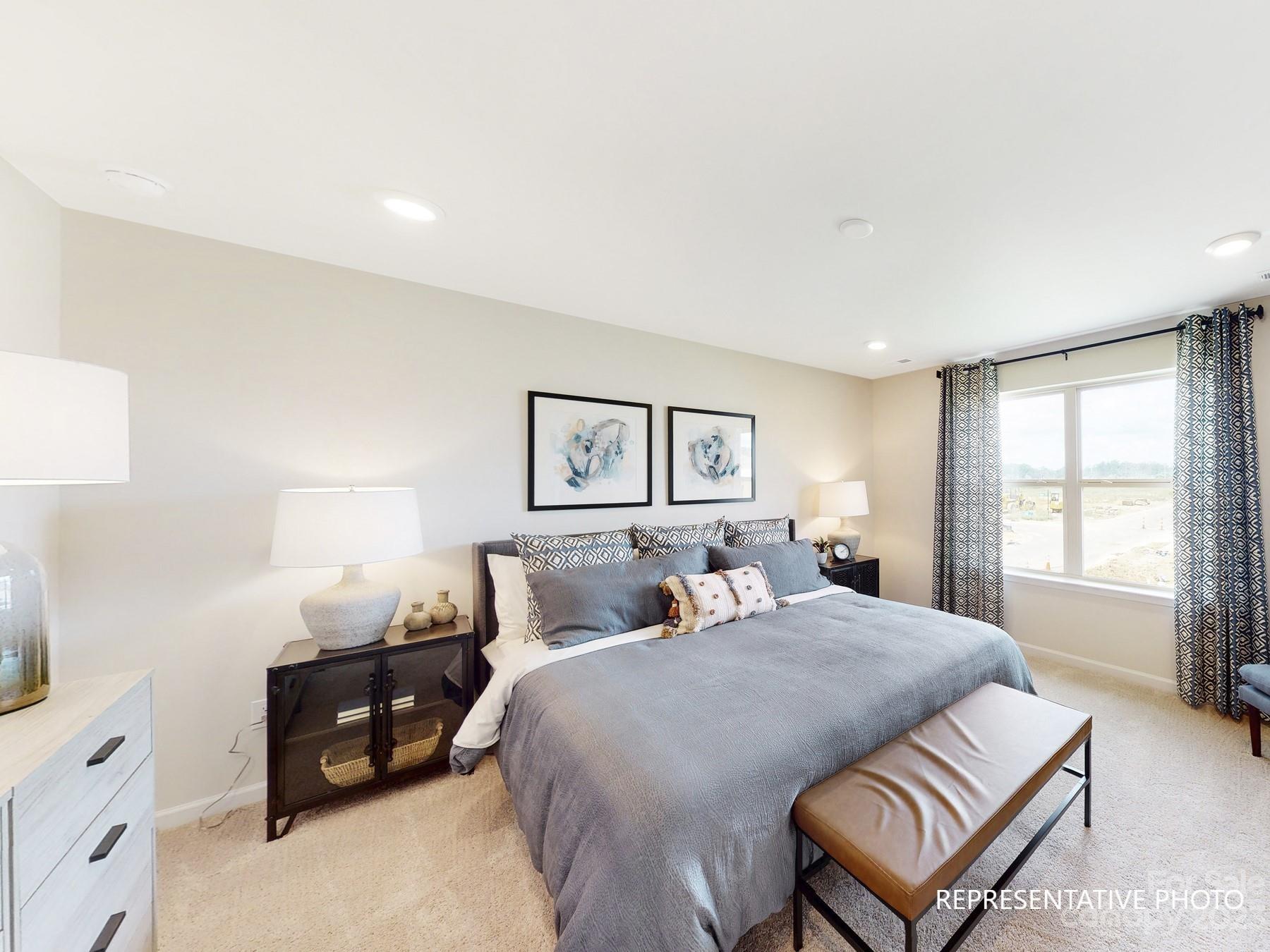 4911 Raspberry Knoll Drive, Unit 41 Charlotte, NC 28208 - Photo 25 of 29 a bedroom with a bed window and a couch