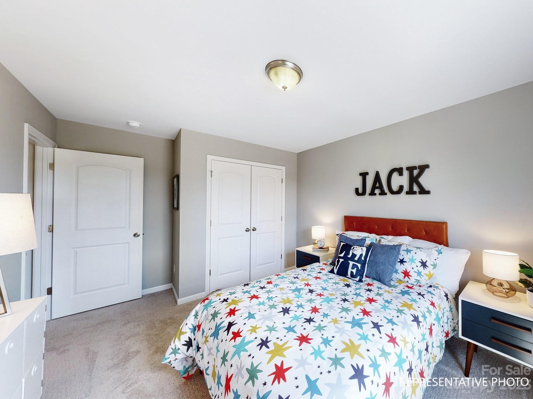 4911 Raspberry Knoll Drive, Unit 41 Charlotte, NC 28208 - Photo 5 of 29 a bedroom with a bed and a window