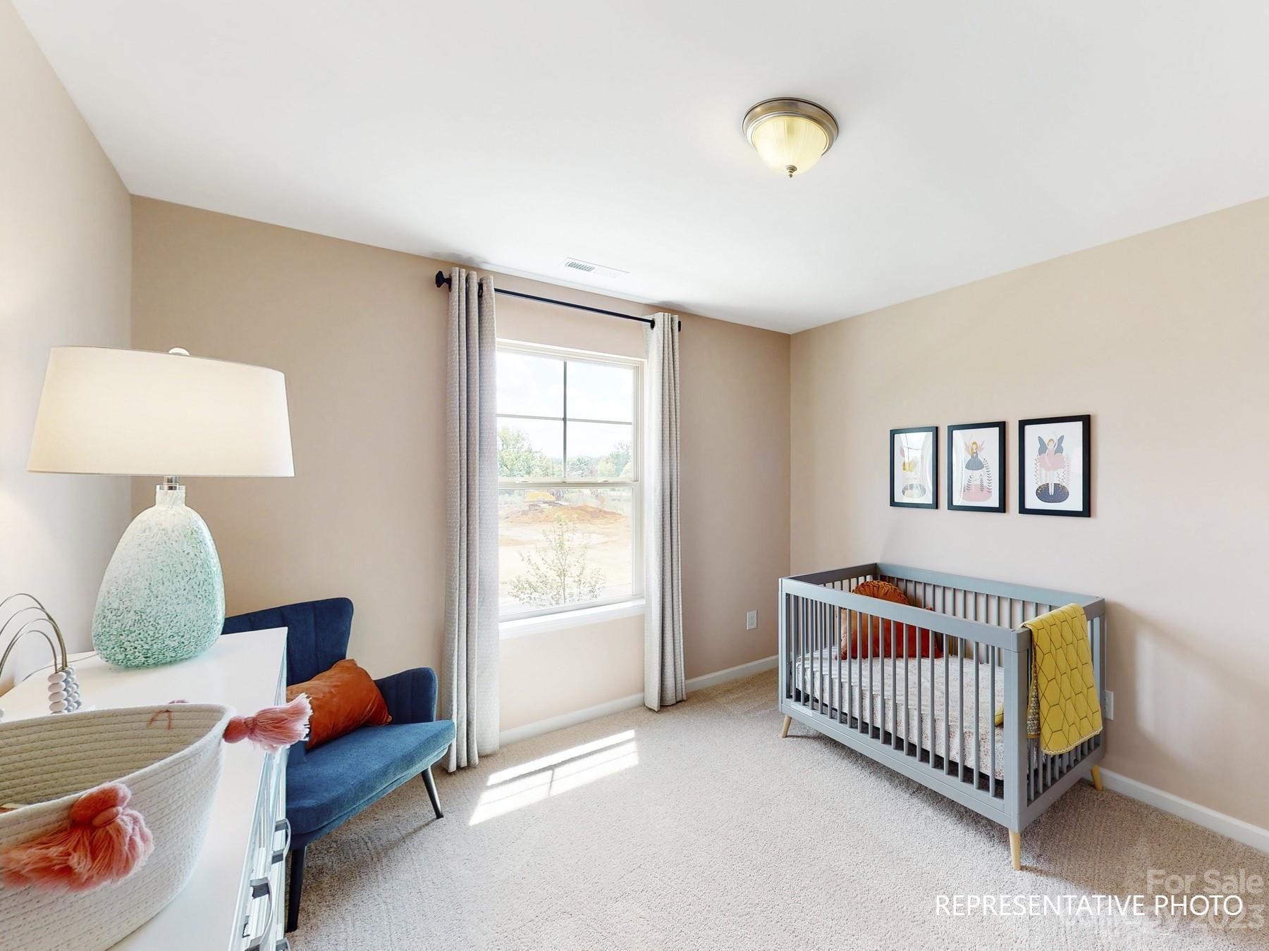 4911 Raspberry Knoll Drive, Unit 41 Charlotte, NC 28208 - Photo 7 of 29 a bedroom with furniture and a window