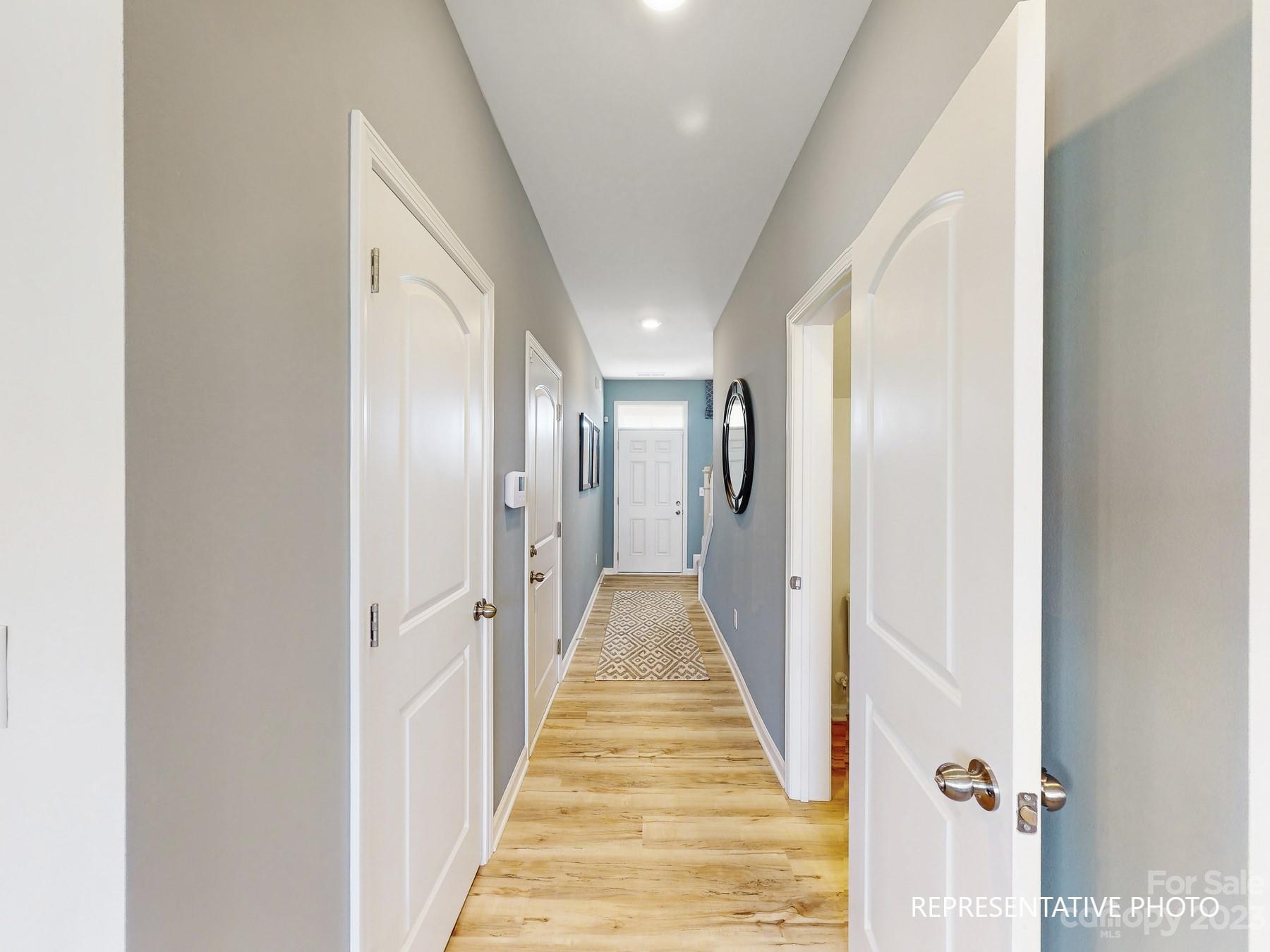 4911 Raspberry Knoll Drive, Unit 41 Charlotte, NC 28208 - Photo 8 of 29 a view of a hallway with wooden floor and a bathroom