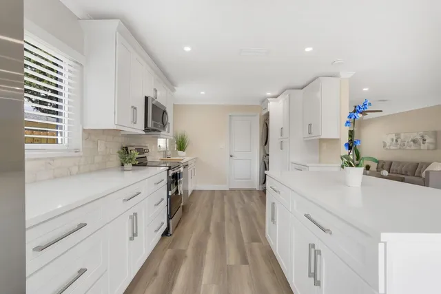 a kitchen with kitchen island a sink stove and cabinets