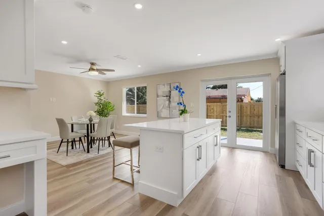 a large kitchen with a table and chairs