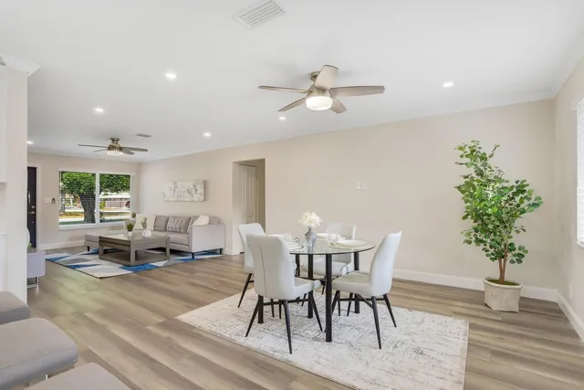 a view of a dining room with furniture window and wooden floor