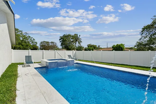 a view of swimming pool with lounge chair