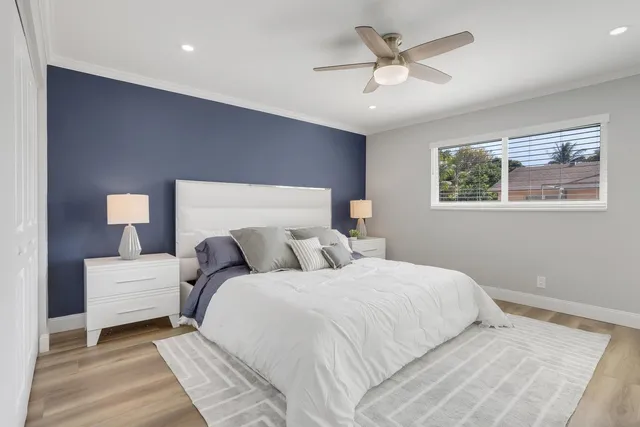 a bedroom with bed and a chandelier