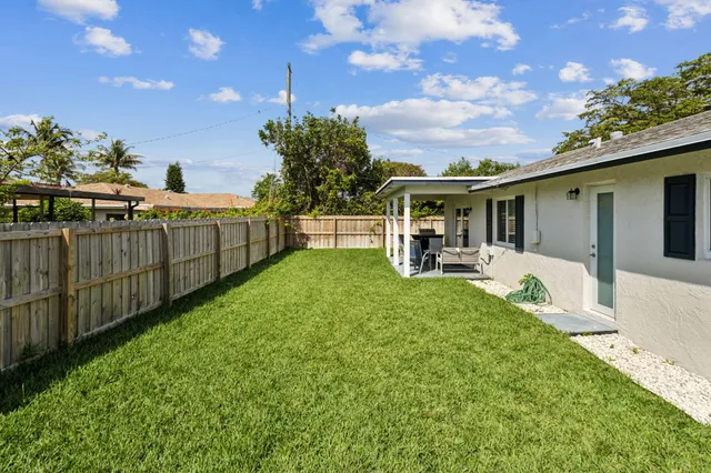 a view of a backyard with a garden and deck