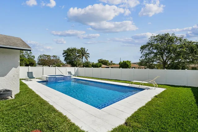 a view of a swimming pool with lounge chair