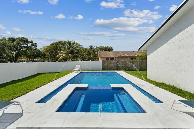 a view of swimming pool with lounge chair
