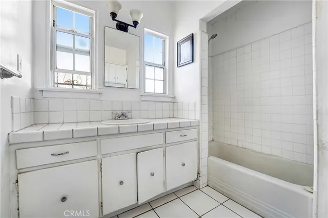 a bathroom with a sink a bathtub and window