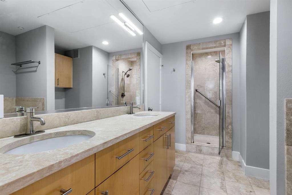 5055 Addison Circle, Unit 731 Addison, TX 75001 - Photo 23 of 40 Well appointed and luxurious primary bath with a large walk-in closet.