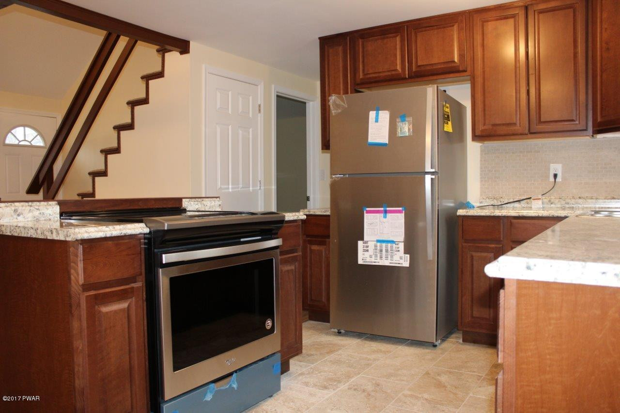 130 Stamford Road Dingmans Ferry, PA 18328 - Photo 4 of 25 a kitchen with stainless steel appliances granite countertop a stove and a cabinets