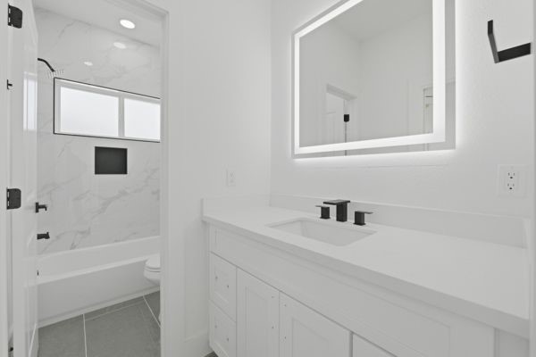6539 Sealey Street Houston, TX 77091 - Photo 25 of 28 a bathroom with a sink a vanity and mirror