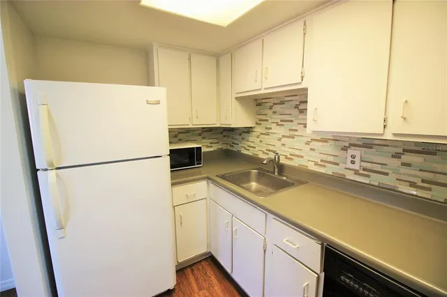 a white refrigerator freezer sitting inside of a kitchen