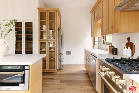 a kitchen with stainless steel appliances granite countertop a stove and a refrigerator