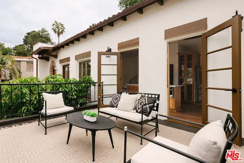 a view of a patio with couches and a potted plant on a table