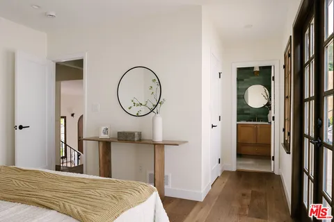 a bedroom with a bed and a mirror