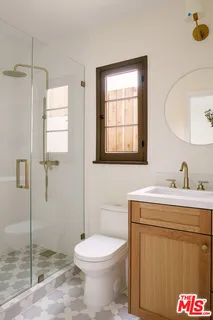 a bathroom with a toilet a sink and a mirror