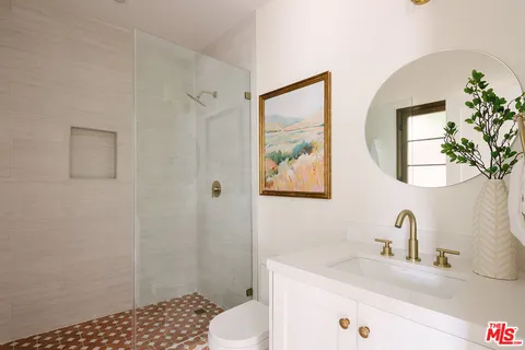 a bathroom with a sink toilet and shower