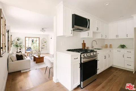 a kitchen with stainless steel appliances a stove a sink and a refrigerator