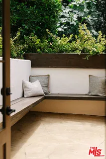 a view of a porch with a table and chairs