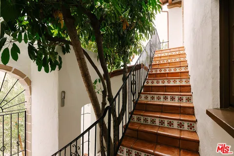 a view of front door and small trees