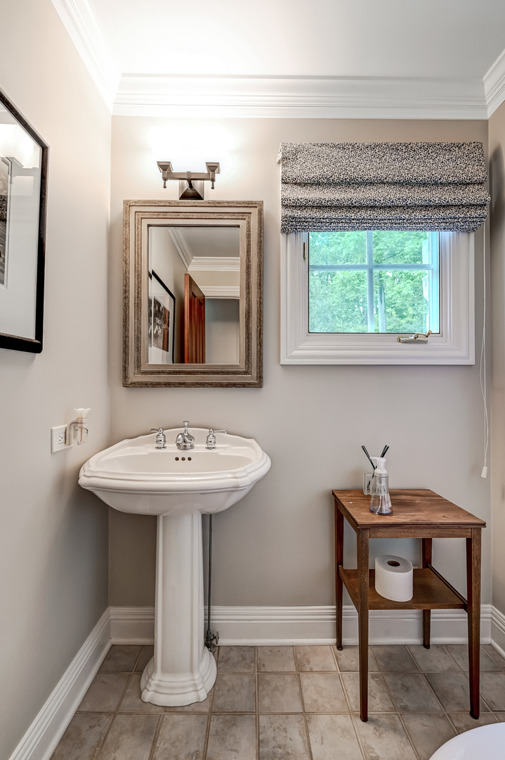 5 Norman Court Burr Ridge, IL 60527 - Photo 28 of 52 a bathroom with a sink and a mirror