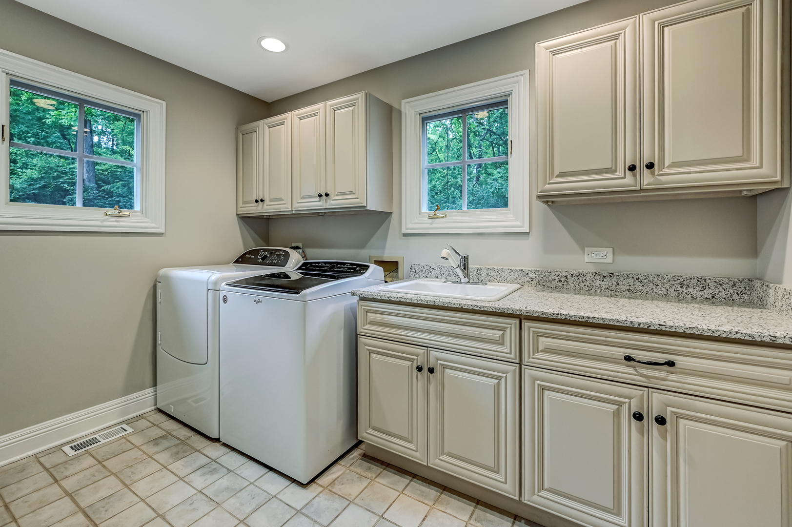 5 Norman Court Burr Ridge, IL 60527 - Photo 29 of 52 a kitchen with granite countertop white cabinets and window