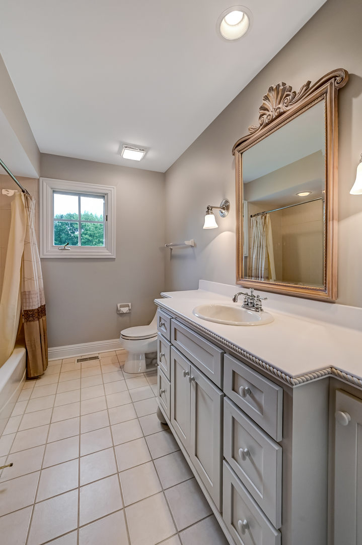 5 Norman Court Burr Ridge, IL 60527 - Photo 32 of 52 a spacious bathroom with a double vanity sink toilet and a mirror
