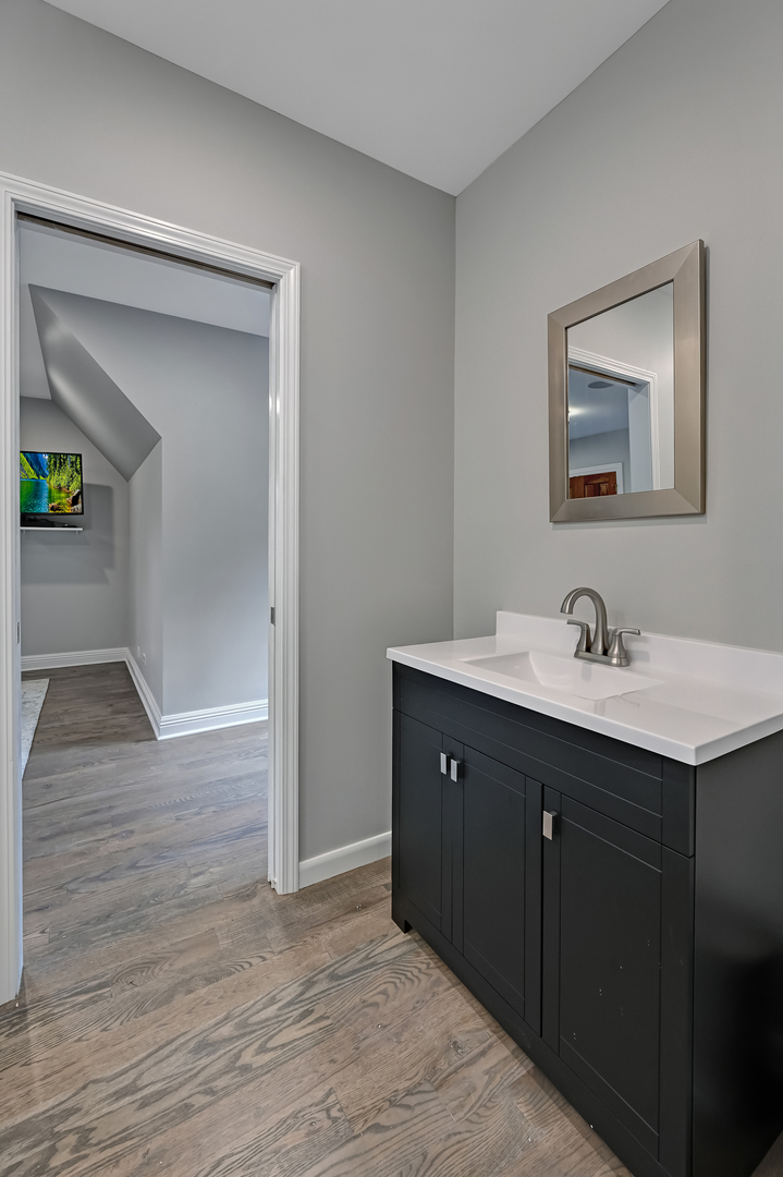 5 Norman Court Burr Ridge, IL 60527 - Photo 37 of 52 a bathroom with a sink and a mirror