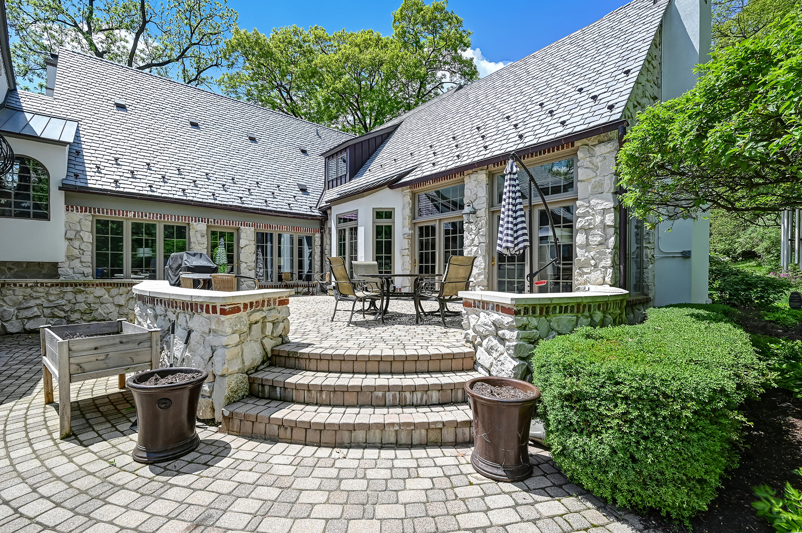 5 Norman Court Burr Ridge, IL 60527 - Photo 47 of 52 a front view of a house with a garden and patio